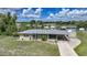 Charming single-story home with attached carport and ample yard space under a blue sky at 3171 Highlands Rd, Punta Gorda, FL 33983
