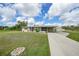 Inviting single-story home featuring a long driveway, carport, and well-maintained lawn on a sunny day at 3171 Highlands Rd, Punta Gorda, FL 33983