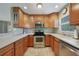 Functional kitchen featuring stainless steel appliances, plenty of counter space, and wood cabinetry at 3171 Highlands Rd, Punta Gorda, FL 33983