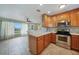 Modern kitchen flows to living space with ample cabinets, countertops, and a stainless steel oven range at 3171 Highlands Rd, Punta Gorda, FL 33983
