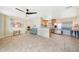 Open-concept living area showcasing tile flooring, a ceiling fan, and seamless flow to the modern kitchen at 3171 Highlands Rd, Punta Gorda, FL 33983