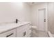 Modern bathroom featuring a white vanity with black hardware and a sleek marble countertop at 37 Oakland Hills Ct, Rotonda West, FL 33947