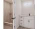 Bathroom featuring a tiled walk-in shower, light wood floors, and white vanity at 37 Oakland Hills Ct, Rotonda West, FL 33947