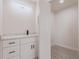 Bathroom featuring marble countertop, modern vanity and fixtures, and open door at 37 Oakland Hills Ct, Rotonda West, FL 33947