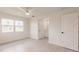 Sun-lit bedroom with wood-look flooring, ceiling fan, and an adjacent bathroom at 37 Oakland Hills Ct, Rotonda West, FL 33947