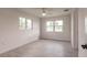 Well-lit bedroom showcasing light-colored walls and wood-look flooring, complemented by two large windows at 37 Oakland Hills Ct, Rotonda West, FL 33947
