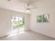 Spacious bedroom with a large sliding glass door to the backyard and a window at 37 Oakland Hills Ct, Rotonda West, FL 33947