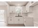 Renovated kitchen featuring bright white cabinets, black hardware, and updated countertops at 37 Oakland Hills Ct, Rotonda West, FL 33947