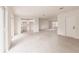 Open-concept living area with light wood-look flooring, recessed lighting, and a view of the adjacent kitchen at 37 Oakland Hills Ct, Rotonda West, FL 33947