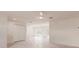 Bright living room boasting light wood-look flooring, sliding glass doors, and a ceiling fan for added comfort at 37 Oakland Hills Ct, Rotonda West, FL 33947
