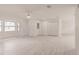 Spacious living room showcases a bay window, stylish front door, light wood-look floors, and ceiling fan at 37 Oakland Hills Ct, Rotonda West, FL 33947