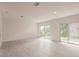 Bright living room showcases recessed lighting, light wood-look flooring, and access to the backyard through sliding doors at 37 Oakland Hills Ct, Rotonda West, FL 33947
