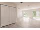 Open-concept living room featuring light wood-look floors, large sliding glass doors, and double-door closet at 37 Oakland Hills Ct, Rotonda West, FL 33947