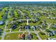 Aerial view of a residential neighborhood showcasing the home's location among lush green lawns and nearby houses at 411 Scarlet Sage, Punta Gorda, FL 33955