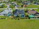 Aerial view of home, lawn and neighborhood with pools at 411 Scarlet Sage, Punta Gorda, FL 33955