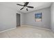 Bedroom features closet, window, ceiling fan and tile flooring for serene comfort at 411 Scarlet Sage, Punta Gorda, FL 33955