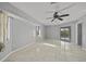 Bedroom features tile flooring, ceiling fan and sliding glass doors to outdoor patio area at 411 Scarlet Sage, Punta Gorda, FL 33955