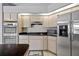 Modern kitchen with stainless steel appliances, including double ovens and a refrigerator with a water dispenser at 411 Scarlet Sage, Punta Gorda, FL 33955