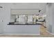 Kitchen view showcasing an eat-in bar area with views into the workspace, lots of cabinets, and great lighting at 411 Scarlet Sage, Punta Gorda, FL 33955