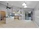 Open kitchen features an island with seating, stainless steel appliances, and tile flooring at 411 Scarlet Sage, Punta Gorda, FL 33955