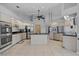 Bright kitchen featuring stainless steel appliances, light-colored cabinets, and a functional island, perfect for cooking at 411 Scarlet Sage, Punta Gorda, FL 33955