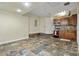 Compact kitchenette area features a cooktop, microwave, and wooden cabinets on tiled floor at 411 Scarlet Sage, Punta Gorda, FL 33955