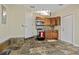 Quaint kitchenette with tiled floor, wooden cabinets, microwave, mini-fridge, and a compact stove at 411 Scarlet Sage, Punta Gorda, FL 33955