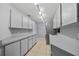 Spacious laundry room with tile flooring, ample counter space, cabinets, and modern washer and dryer units at 411 Scarlet Sage, Punta Gorda, FL 33955
