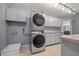 Laundry area with stacked washer and dryer, utility sink and counter space and adjacent view to living room at 411 Scarlet Sage, Punta Gorda, FL 33955