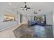 Open-concept living room with high ceilings, unique stone flooring, and a comfortable sectional sofa, great for gatherings at 411 Scarlet Sage, Punta Gorda, FL 33955