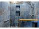 Custom walk-in shower features stone tiling with built-in shelves and grab bar at 411 Scarlet Sage, Punta Gorda, FL 33955