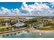 Panoramic aerial of lakefront community with pier, restaurant, and recreation areas at 42346 Waterfront Way, Punta Gorda, FL 33982