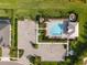 Community pool with lounge chairs, lush landscaping, and convenient parking at 42346 Waterfront Way, Punta Gorda, FL 33982