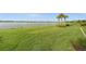 Beautifully maintained backyard with lush green grass and a tranquil lake view at 42346 Waterfront Way, Punta Gorda, FL 33982
