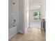 Bathroom featuring a tub/shower combo, tiled floors and access to the bedroom at 42346 Waterfront Way, Punta Gorda, FL 33982