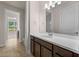 Bathroom featuring a single sink vanity with granite counters, tiled floors and walk-in shower at 42346 Waterfront Way, Punta Gorda, FL 33982
