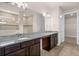 Bathroom featuring a dual sink vanity with granite counters, tiled floor and walk-in shower at 42346 Waterfront Way, Punta Gorda, FL 33982