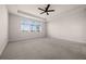 Bright, large bedroom with neutral carpet, tray ceiling, fan and large window at 42346 Waterfront Way, Punta Gorda, FL 33982