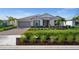 Charming single-story home with manicured lawn, stone driveway, and inviting curb appeal at 42346 Waterfront Way, Punta Gorda, FL 33982