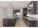 Spacious kitchen with stainless steel appliances, granite counters, and a large center island at 42346 Waterfront Way, Punta Gorda, FL 33982