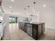 Modern kitchen with island, pendant lighting, stainless steel dishwasher, and an open floorplan at 42346 Waterfront Way, Punta Gorda, FL 33982