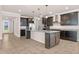 Open concept kitchen with large center island, granite countertops, and stainless steel appliances at 42346 Waterfront Way, Punta Gorda, FL 33982
