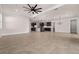 Expansive living room showcasing an open layout with tile flooring, ceiling fan and modern chandelier at 42346 Waterfront Way, Punta Gorda, FL 33982