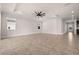 Inviting living room featuring a ceiling fan, tile flooring, and ample natural light at 42346 Waterfront Way, Punta Gorda, FL 33982