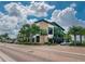 Modern office building with stone accents, surrounded by trees and landscaping, and ample parking at 42346 Waterfront Way, Punta Gorda, FL 33982