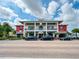 Charming two-story restaurant with outdoor seating and balconies, offering a vibrant dining experience at 42346 Waterfront Way, Punta Gorda, FL 33982