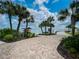 Scenic waterfront walkway leading to a kayak launch, surrounded by lush greenery and palm trees at 42346 Waterfront Way, Punta Gorda, FL 33982