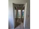 Hallway with bi-fold mirrored closet doors leading to the bathroom at 4424 Baroda Ave, North Port, FL 34287