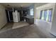 Kitchen with white refrigerator, stainless steel sink, dark cabinets and sliding glass door to the exterior at 4424 Baroda Ave, North Port, FL 34287