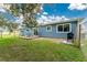 Spacious backyard featuring a wooden deck with table, grill, and a well-maintained lawn at 4583 S Salford Blvd, North Port, FL 34287